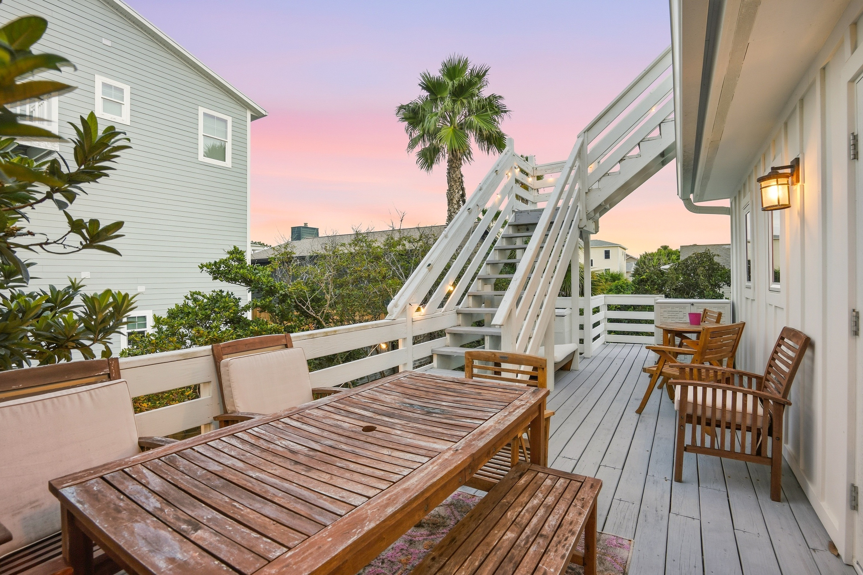 This picture, taken from the Eagle's Nest, looks down on the deck where you can see the outdoor dining table on the second-story deck, and the cozy backyard with its inviting firepit. A perfect blend of outdoor living spaces for relaxation and entertaining