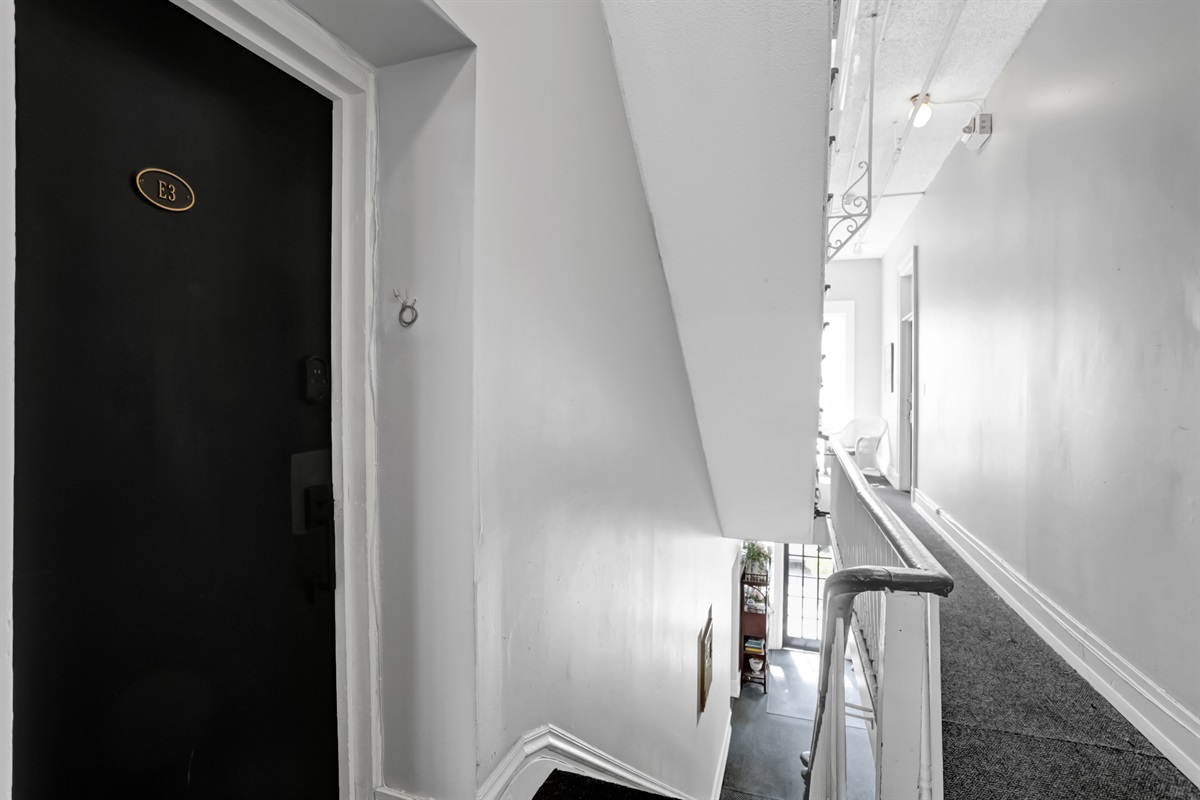 Door to a quiet hallway just off the stairs for easy access.