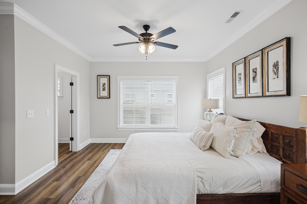 King bed dressed in soft 100% cotton sheets, with a ceiling fan overhead