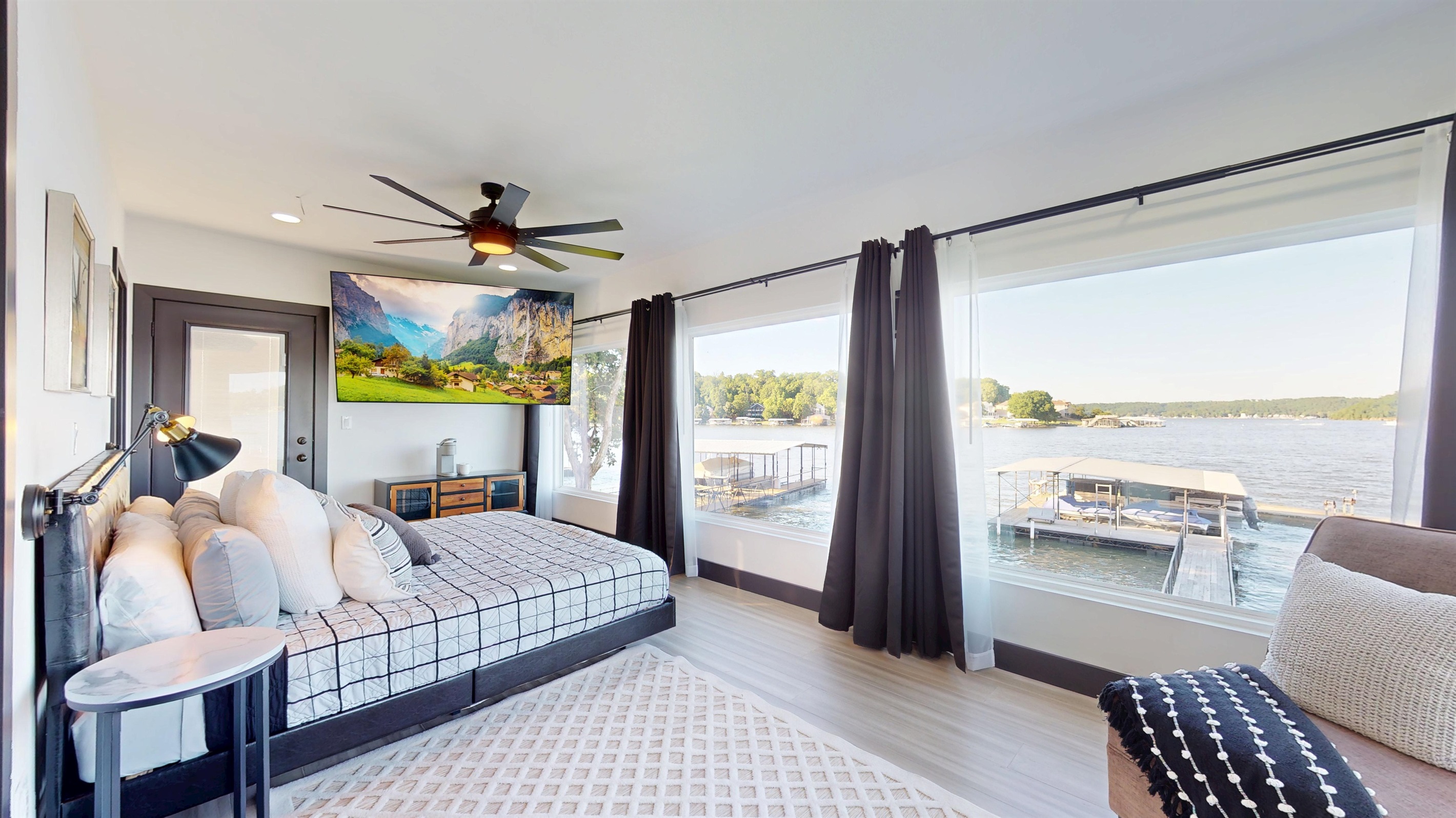 Primary Bedroom has king bed with an ensuite bathroom, 85" TV, Keurig coffee maker, and private balcony access.
