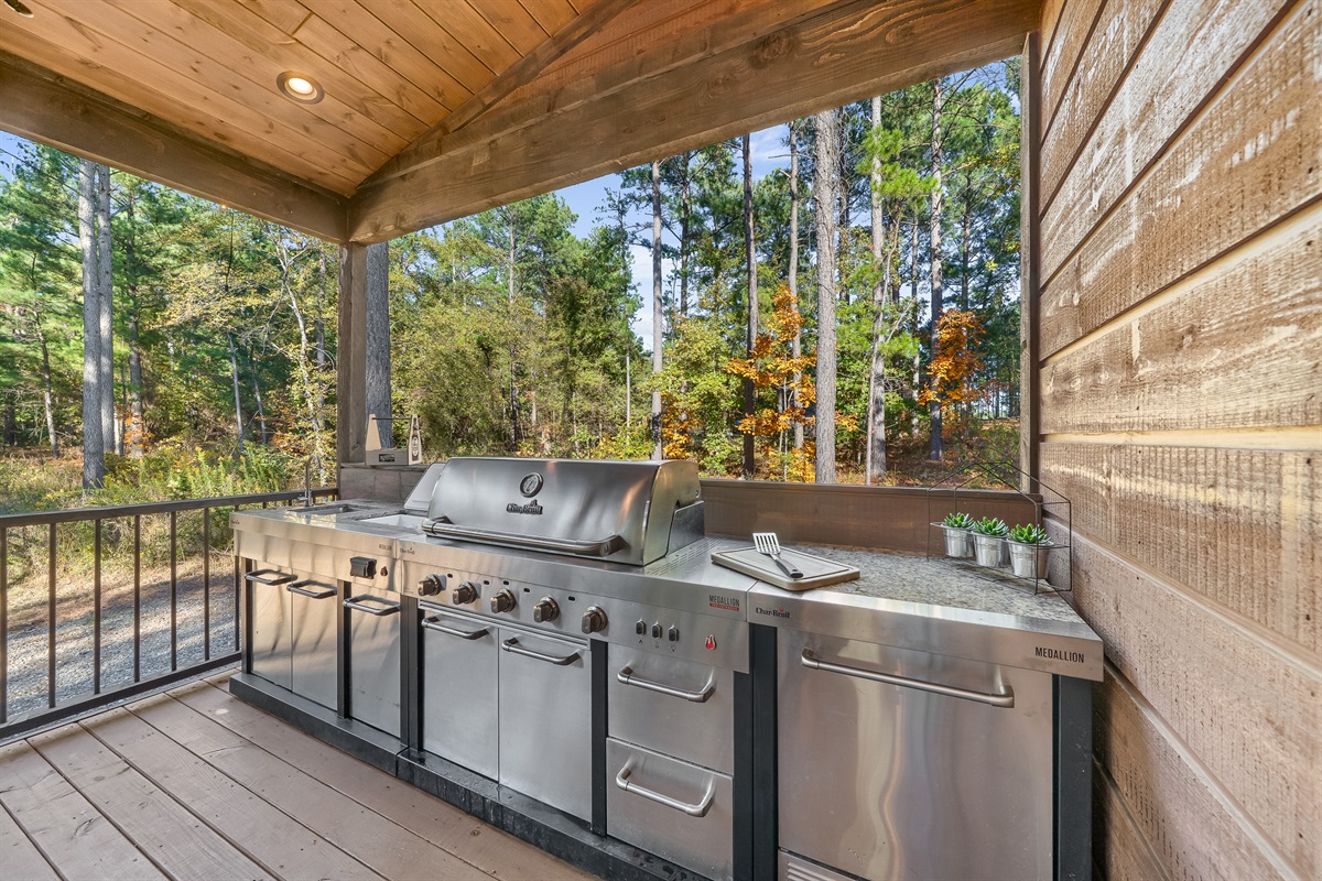 A chef ready outdoor kitchen surrounded by pines. Grill, gather, and enjoy every meal with nature as your backdrop.