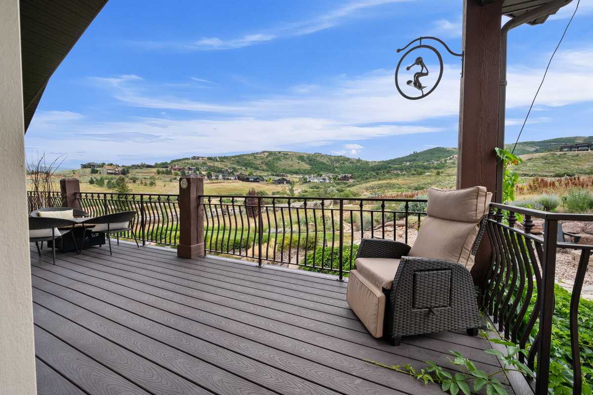 Peaceful outdoor seating area overlooking open space, rolling hills, and unforgettable mountain scenery.