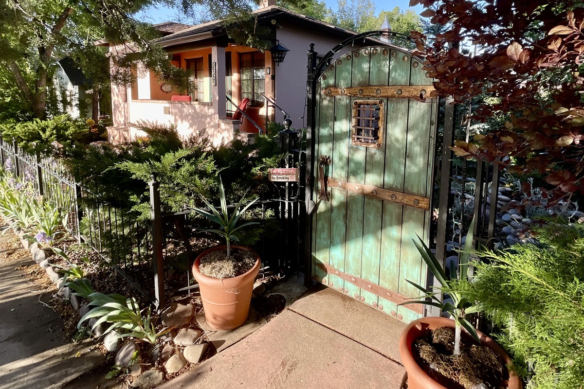 Step through this enchanting green gate and discover a hidden oasis.