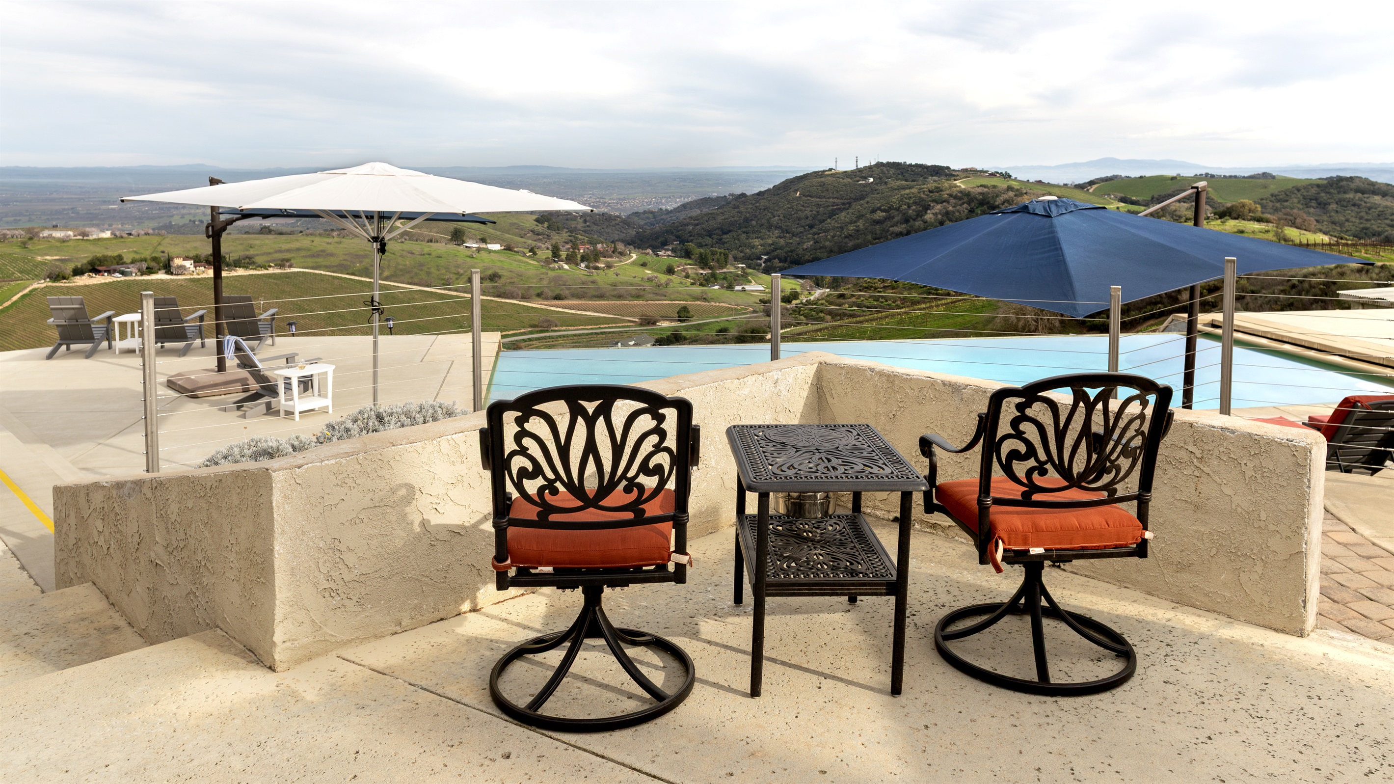 A tucked-away perch above the infinity pool where the vineyards roll away in every direction. Quite possibly the best seat on the property — and there's a lot of competition.