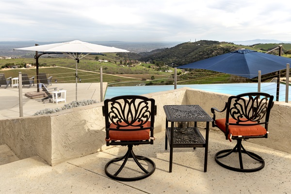 A tucked-away perch above the infinity pool where the vineyards roll away in every direction. Quite possibly the best seat on the property — and there's a lot of competition.