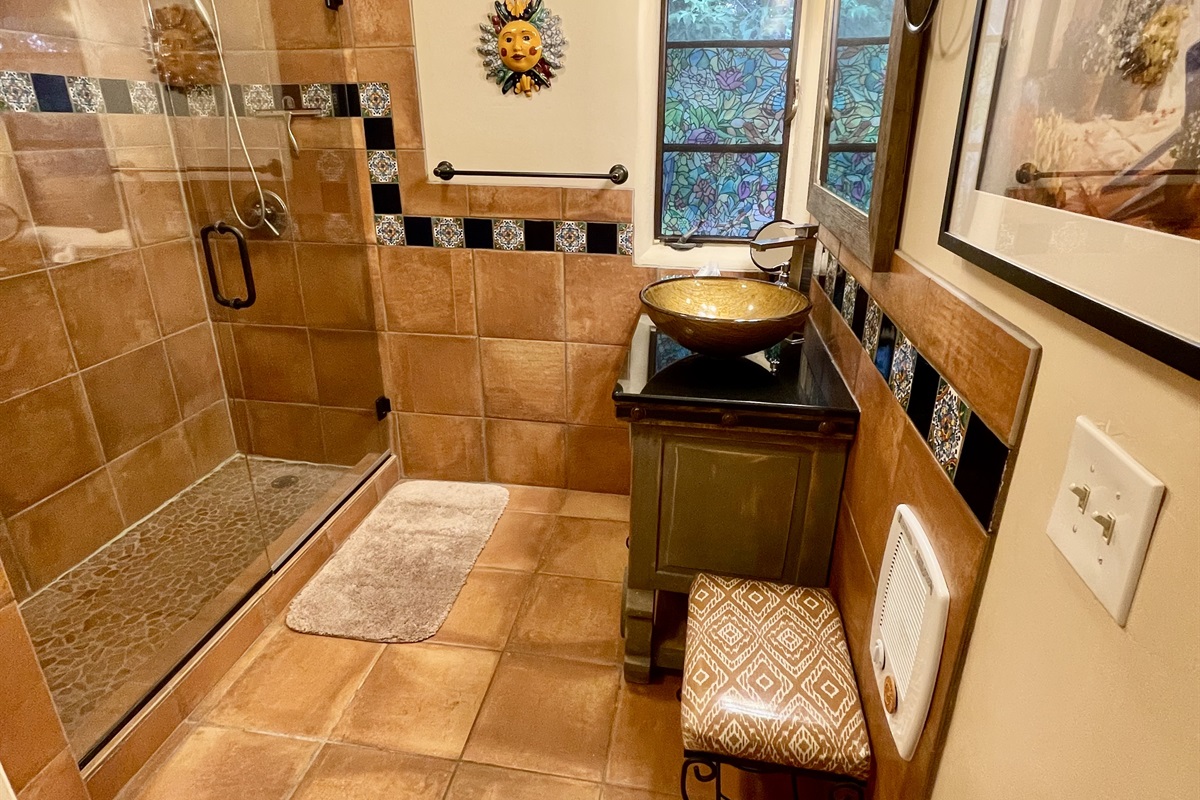 Relax and rejuvenate in this beautifully remodeled bathroom.