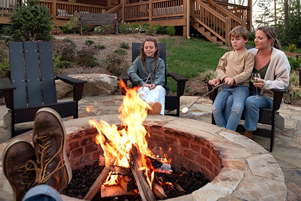 Golden hour glow meets fireside magic. Your mountain escape starts here: cozy chairs, crackling flames, and cabin charm for days.