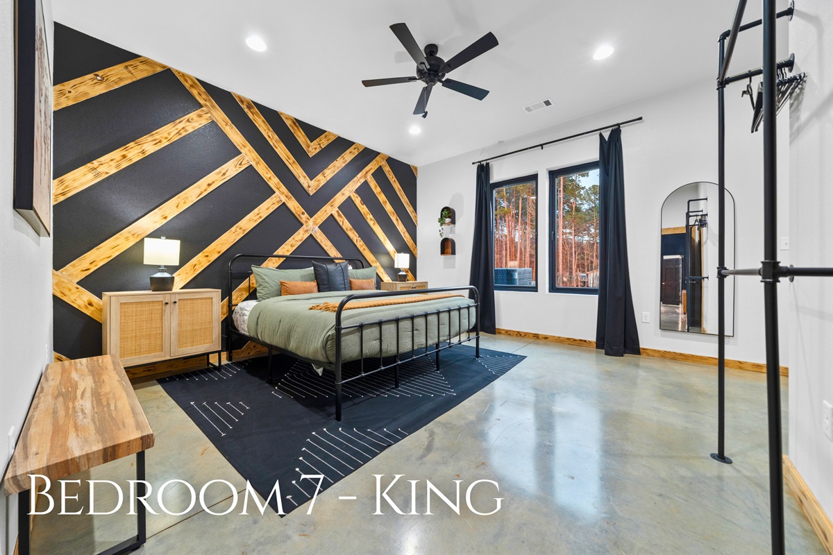 Bedroom 7 stands out with its bold accent wall and king bed, adding a touch of personality to a comfortable space.