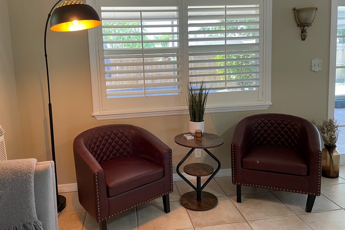 Our expansive rear living room has an abundance of seating and cozy nooks, as well as a comfortable couch with recliners.