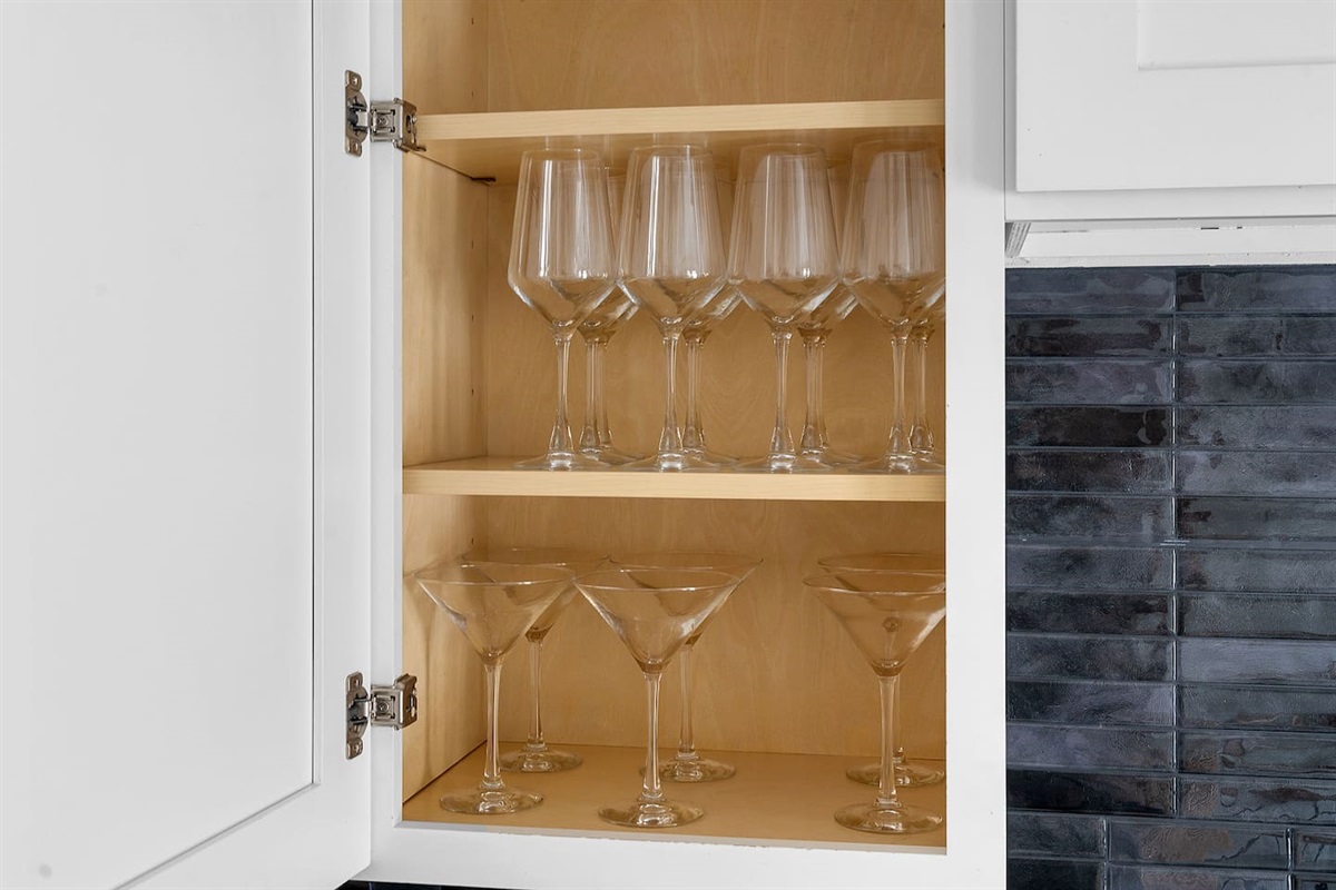 Enjoy a selection of glassware neatly stored in the kitchen cabinet. Whether for wine or cocktails, you'll find the perfect glass for your drink.