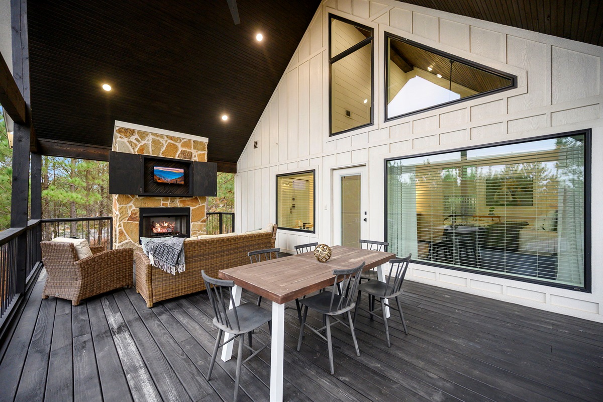 Covered deck with fireplace &mdash; outdoor living at its finest 🔥