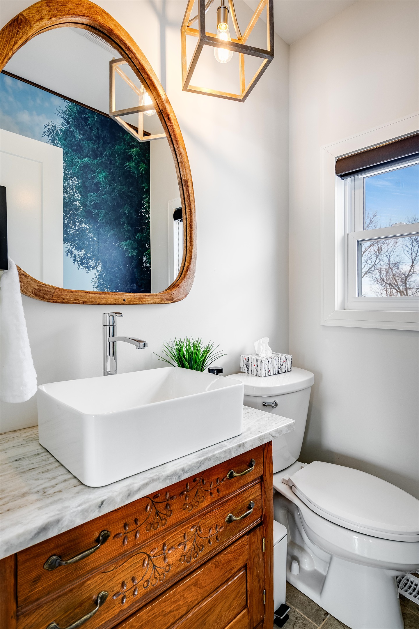 Half Bathroom with Wood accents root the space, bringing warmth to purity.