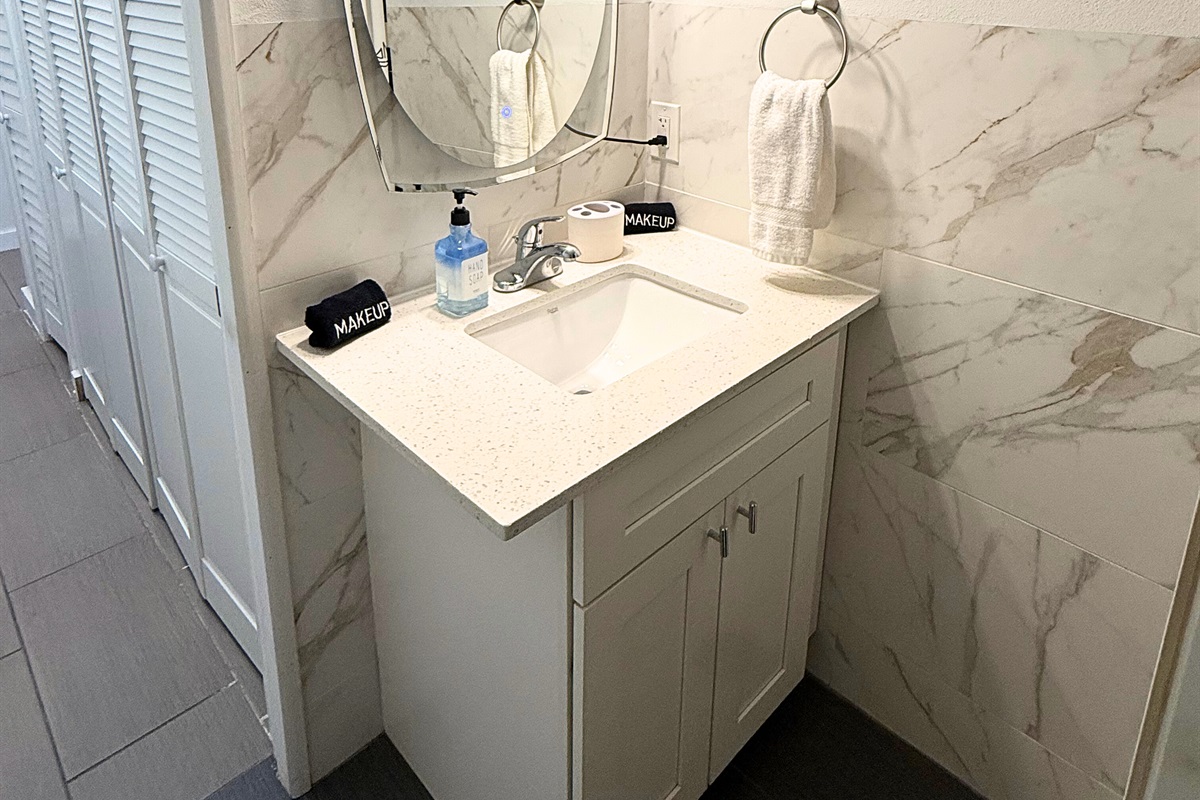 Guest bathroom is down the hall from the two guest rooms