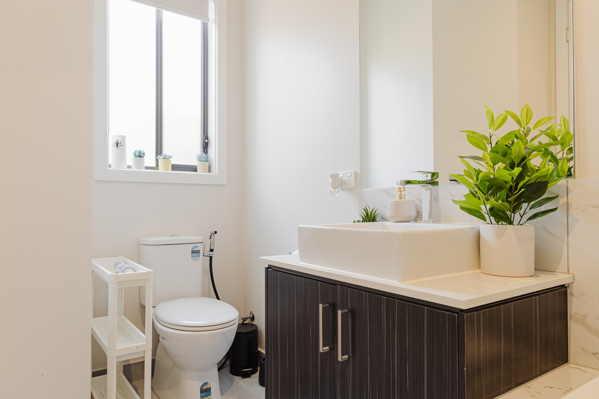 A full bathtub gives this bathroom extra appeal, adding a relaxed soak option alongside the home’s comfortable guest spaces.