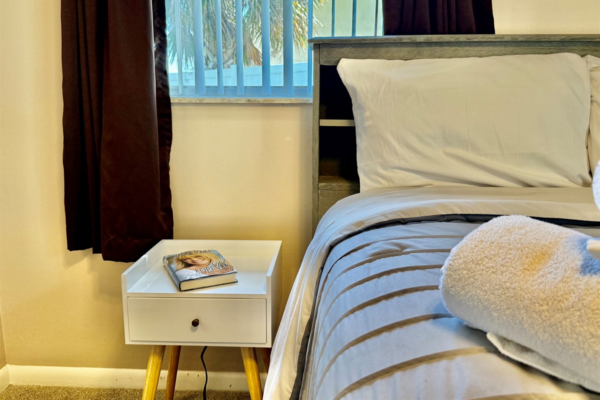 From the comfortable bedding to the modern ceiling fan and calming color palette, this space is designed for true rest and relaxation.