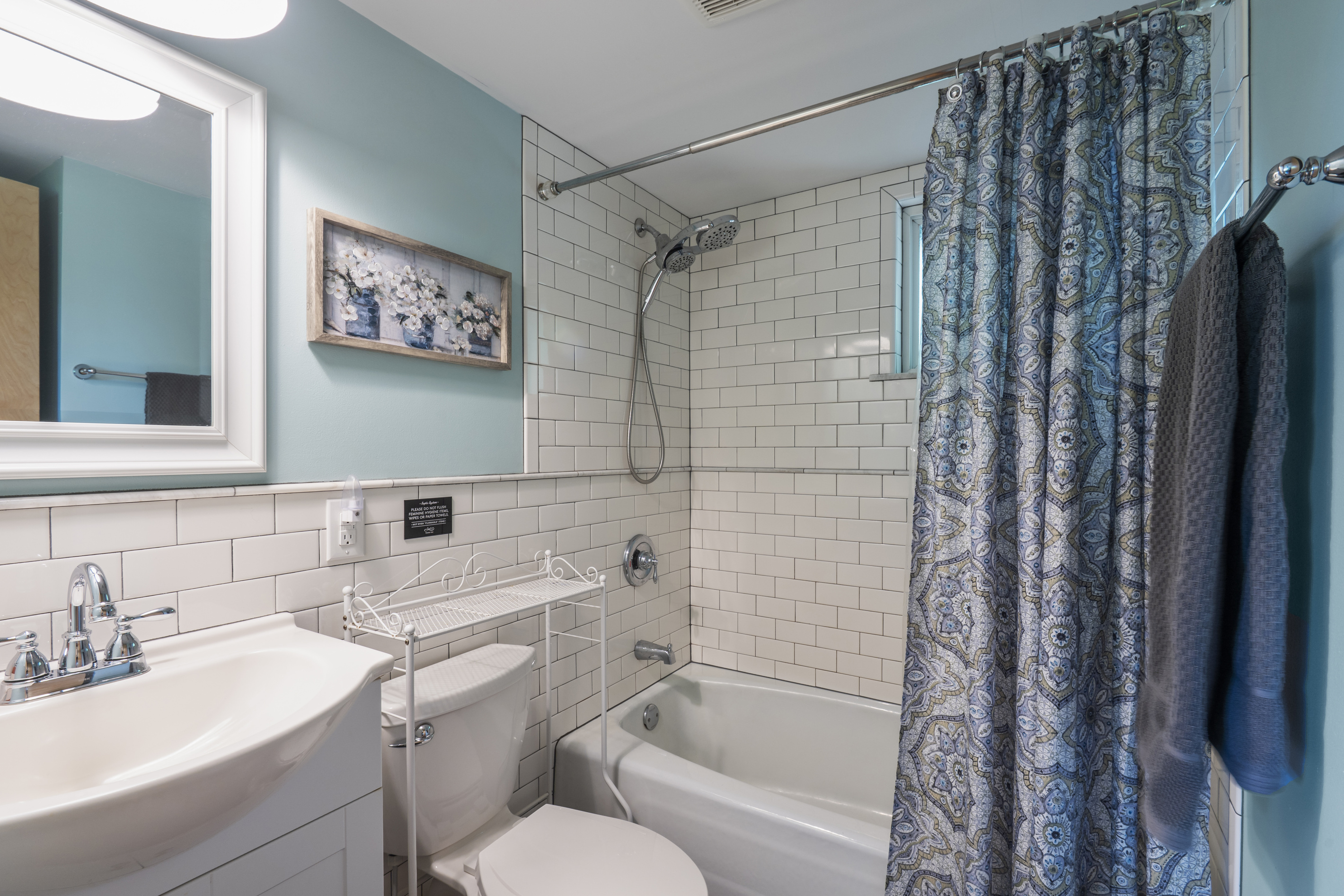 Full bathroom with modern tub/shower combo. Return from a day of hiking or biking to a rain showerhead or a sprayer with multiple settings. 