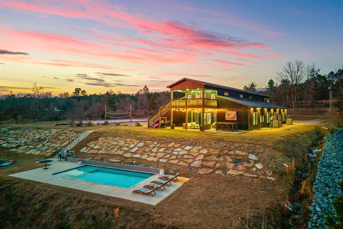 Another twilight view highlights the peaceful setting and welcoming glow of the lodge at dusk.