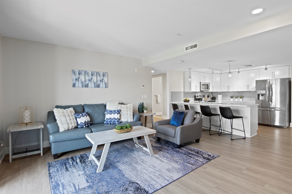 A sleek and functional space with a contemporary design, offering a full kitchen, inviting living area, and a seamless flow for dining and entertainment.