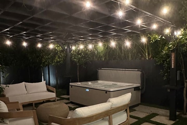 Soak in the magic of the evening beneath the stars in our luxurious Bullfrog spa, tucked beneath a charming pergola adorned with ambient lighting and the gentle fragrance of climbing jasmine—perfect for unwinding and letting the day melt away.