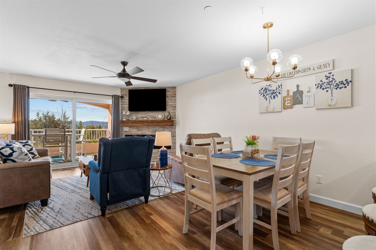 Open dining and living area with comfortable seating and balcony access.