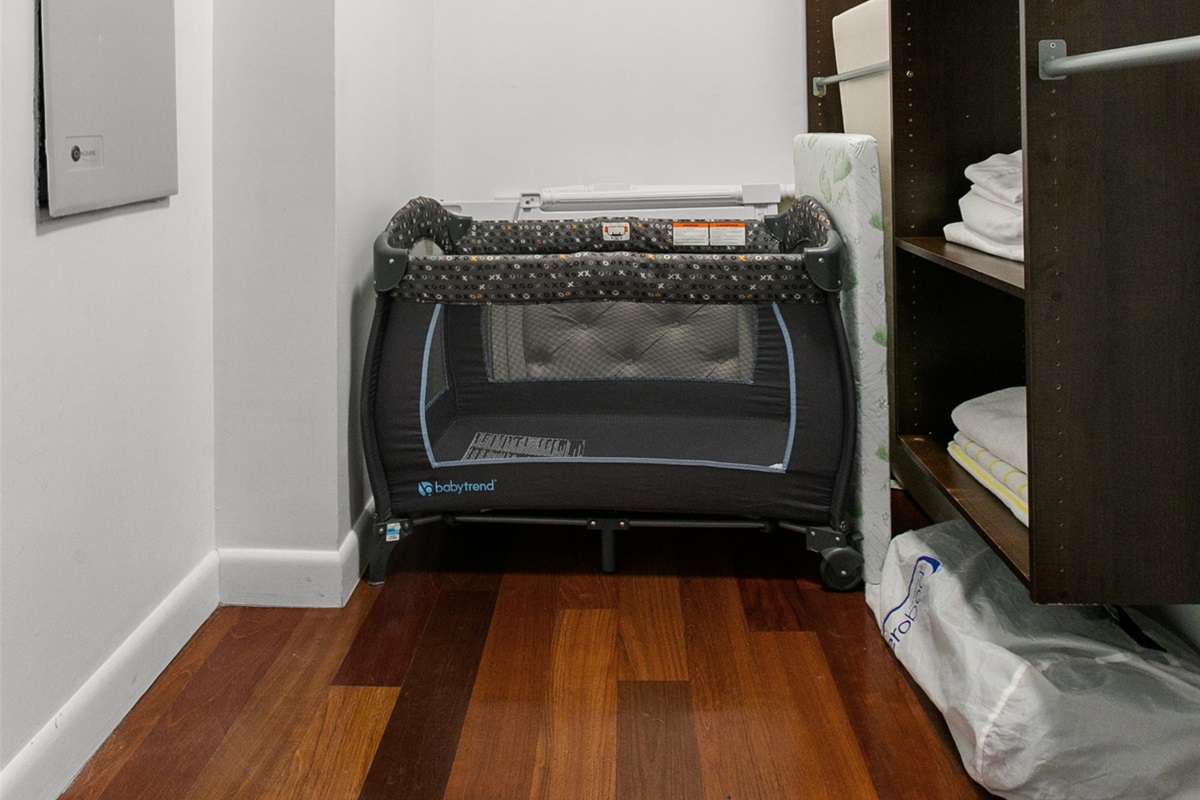 Large walk in closet with baby crib, air mattress and extra linens