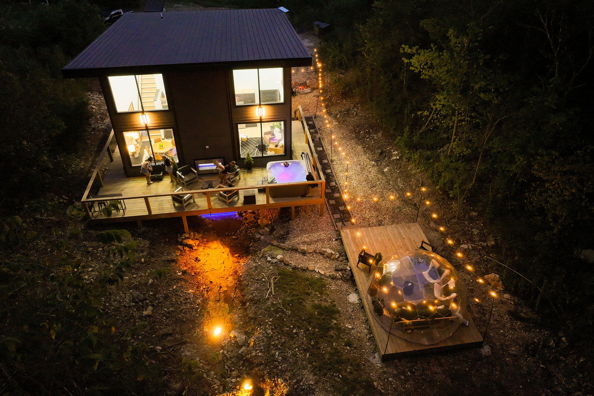 Stay above an Ozark creek surrounded by two wooded acres.