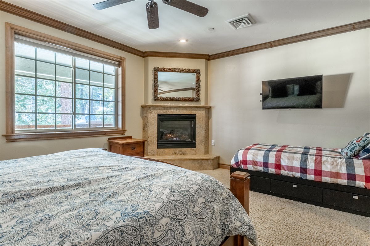 The Charming Chalet primary bedroom fireplace adds warmth and comfort—perfect for relaxing afternoons or cozy evenings in. An addition twin bed is great for kids or extra guests.