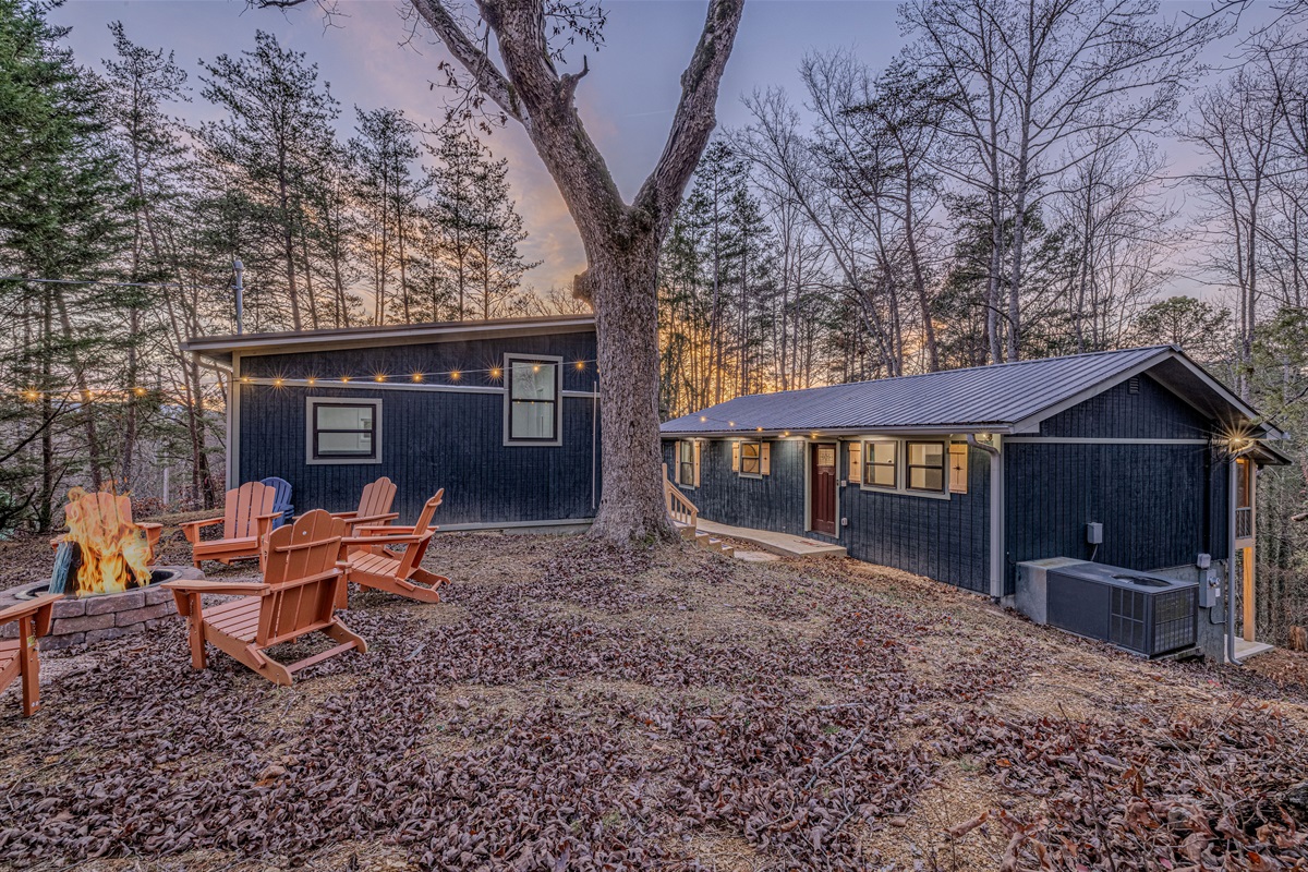 Gather 'round! Our custom stone fire pit and bright orange chairs are ready for s'mores and evening mountain stories.
