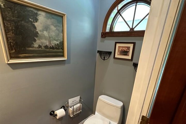 3rd Bathroom which has a sink and toilet (1/2 bath) on the first floor next to the kitchen