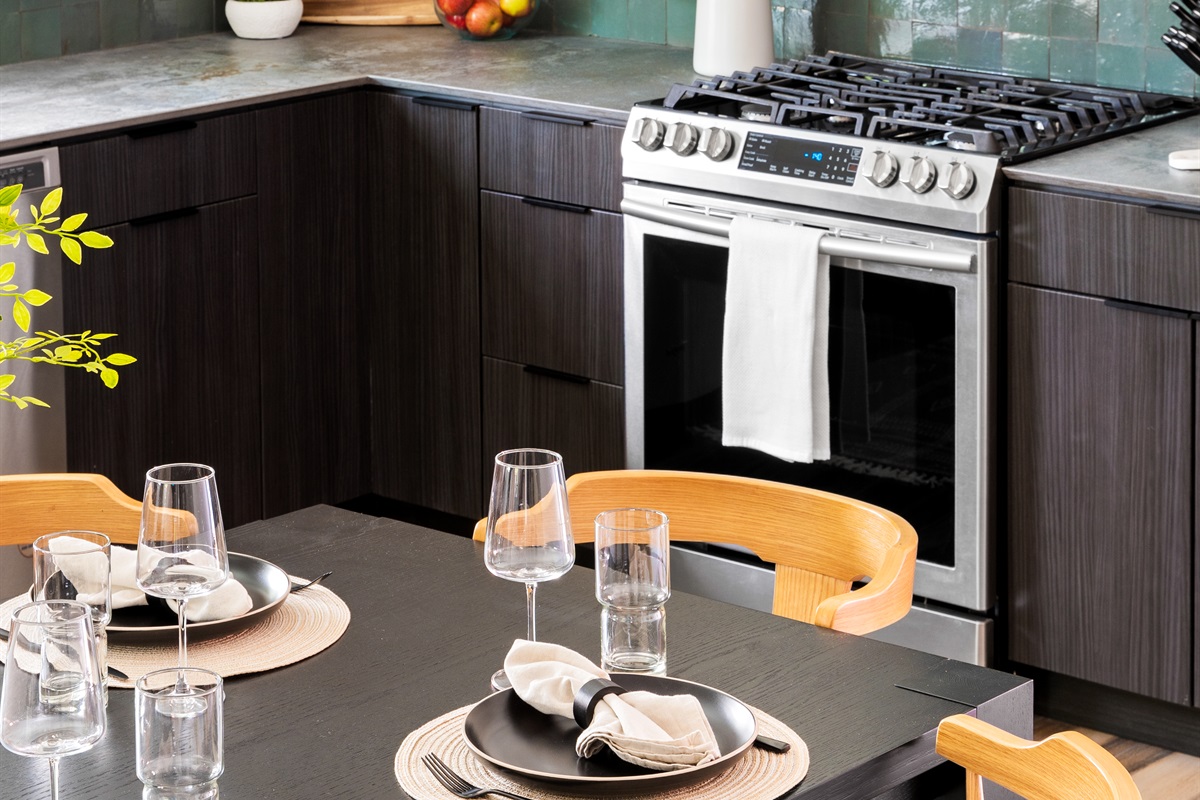 Modern kitchen with sleek design, open shelving, and a stylish dining area, perfect for gatherings.