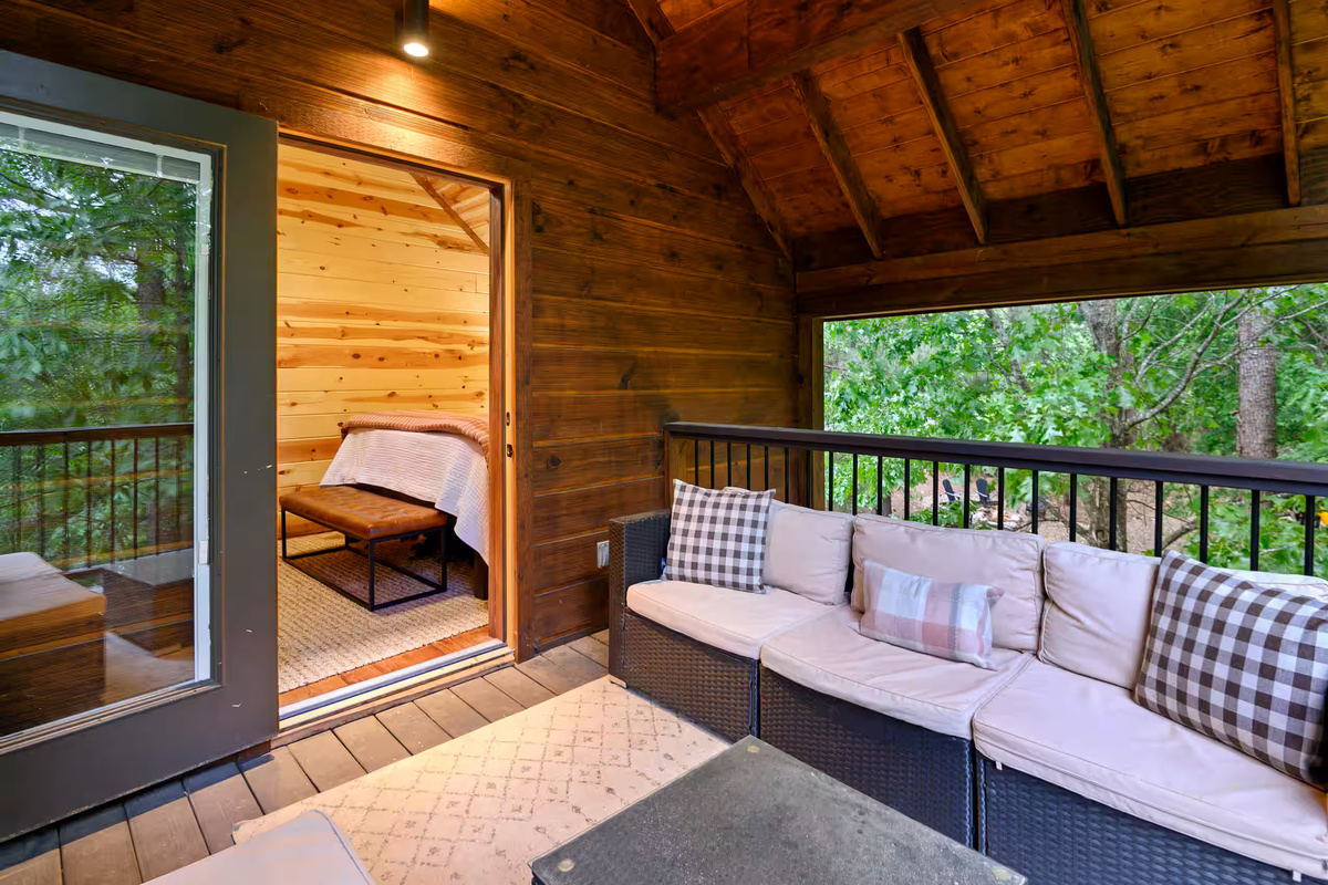 Porch Retreat: Enjoy nature views from the stylish seating in this inviting outdoor space!