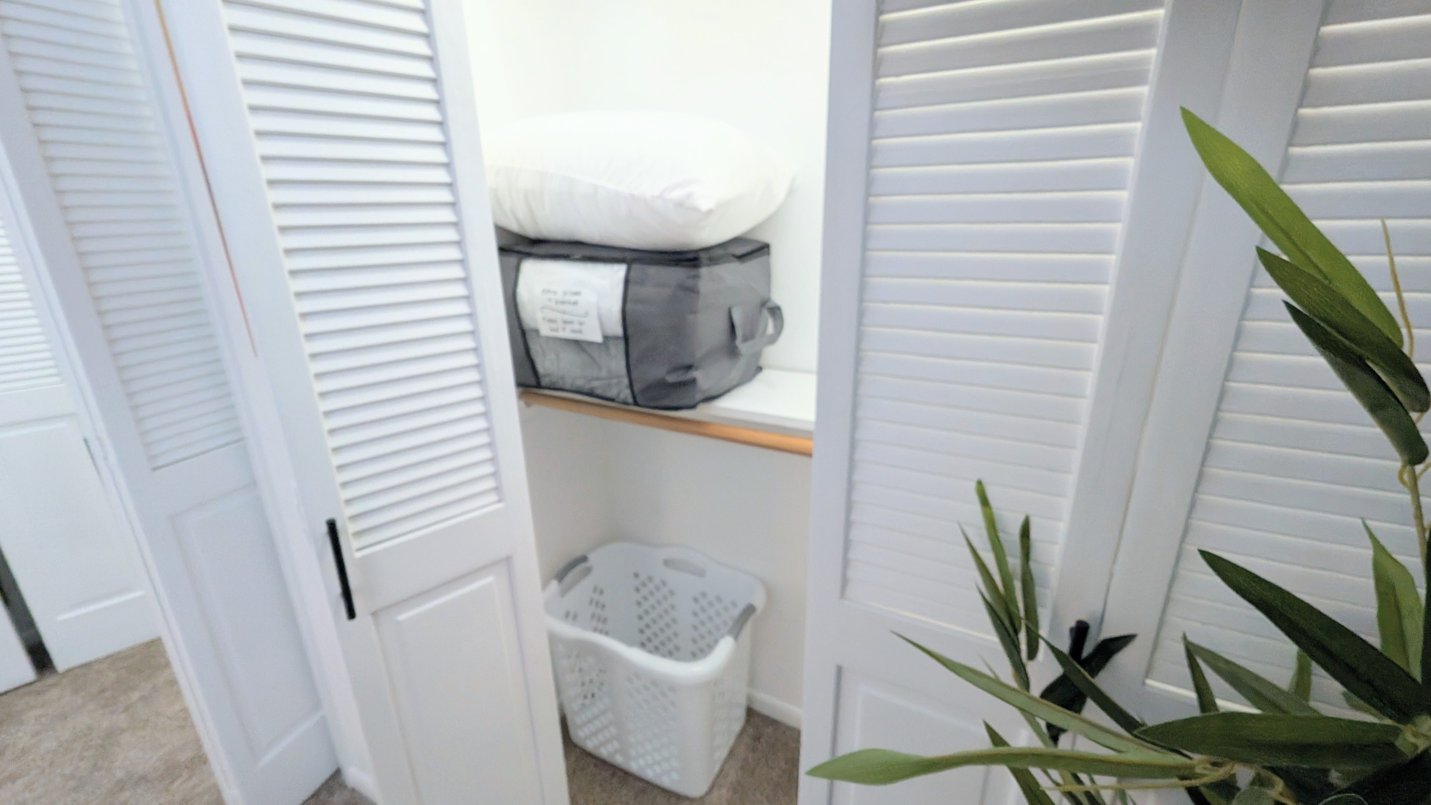 The second closet is stocked with a laundry basket, plus extra blankets and pillows for added comfort. 