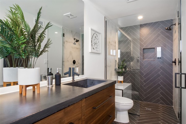 Private apartment bathroom with walk-in shower and marble bench
