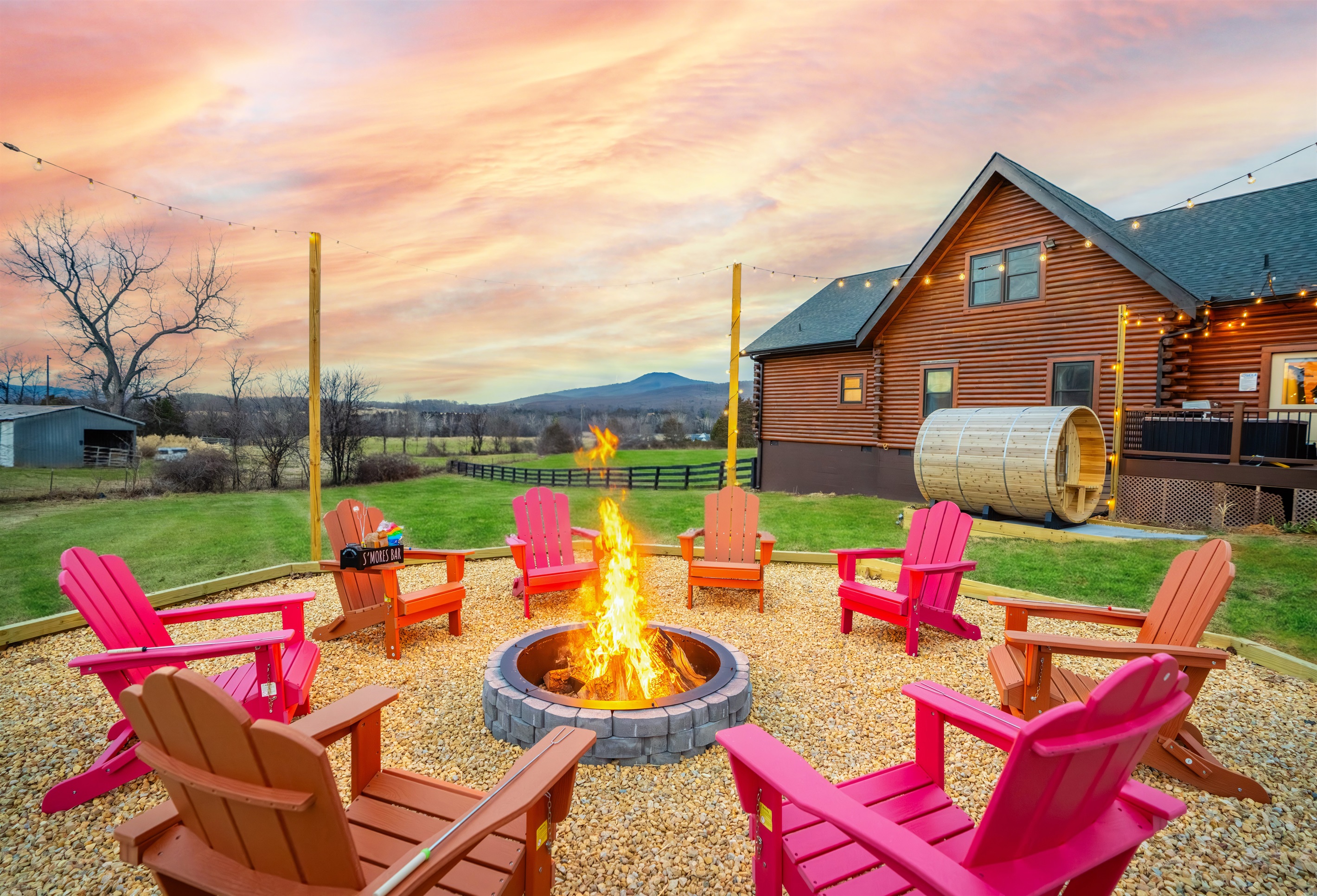 Gather around the fire under open skies. Adirondack chairs, mountain air, S'mores in hand, and the whole group together after a day of Shenandoah adventures.