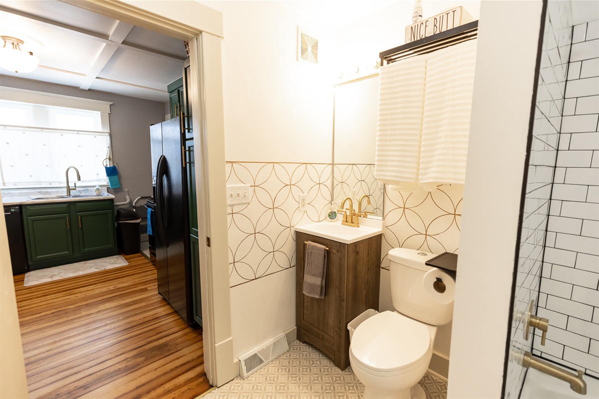 Bathroom off the kitchen and passes through to larger bedroom's walk through closet.
