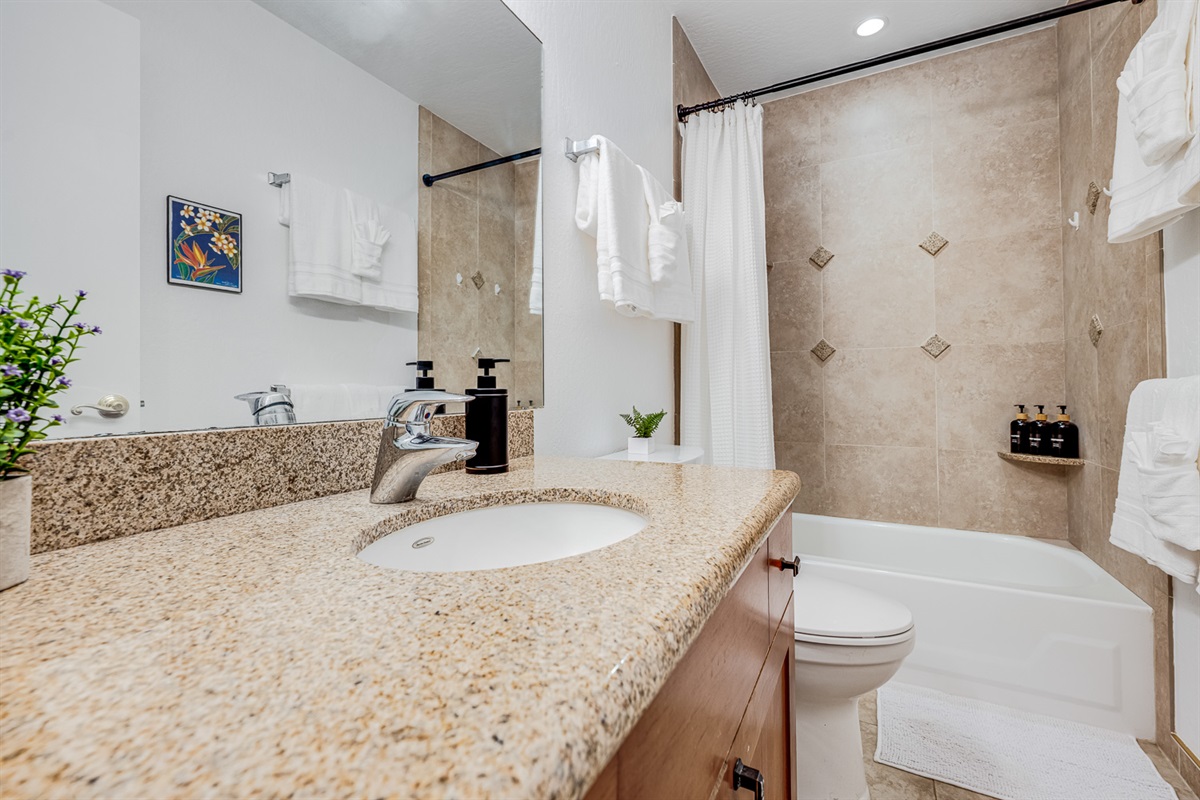 Bright, welcoming bathroom with full tub and shower