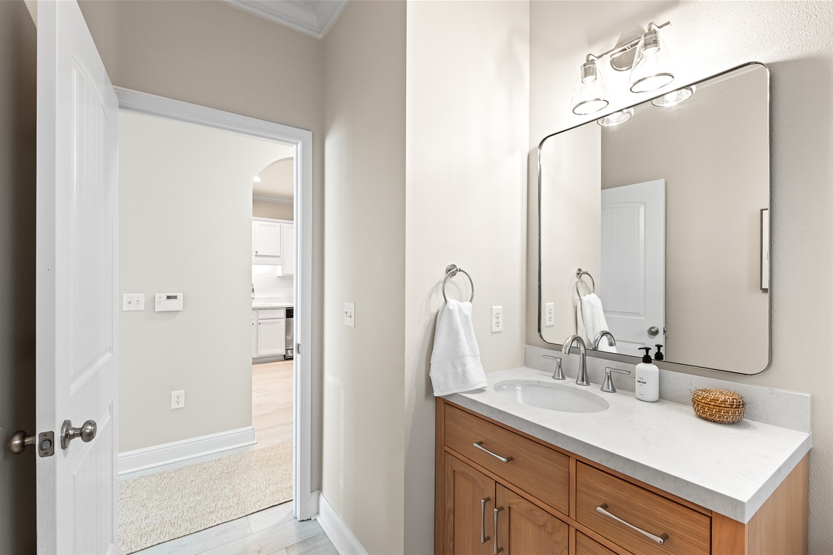 Half Bath 1st Floor: Modern fixtures and a clean, coastal aesthetic define this guest bathroom.