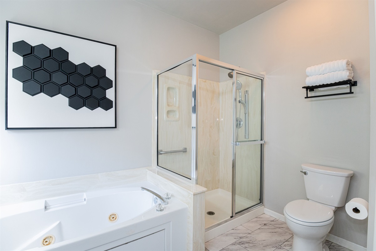 Step into comfort with this attached full bath, just off the main level king bedroom. Clean, bright, and perfect for unwinding after a day in the city.