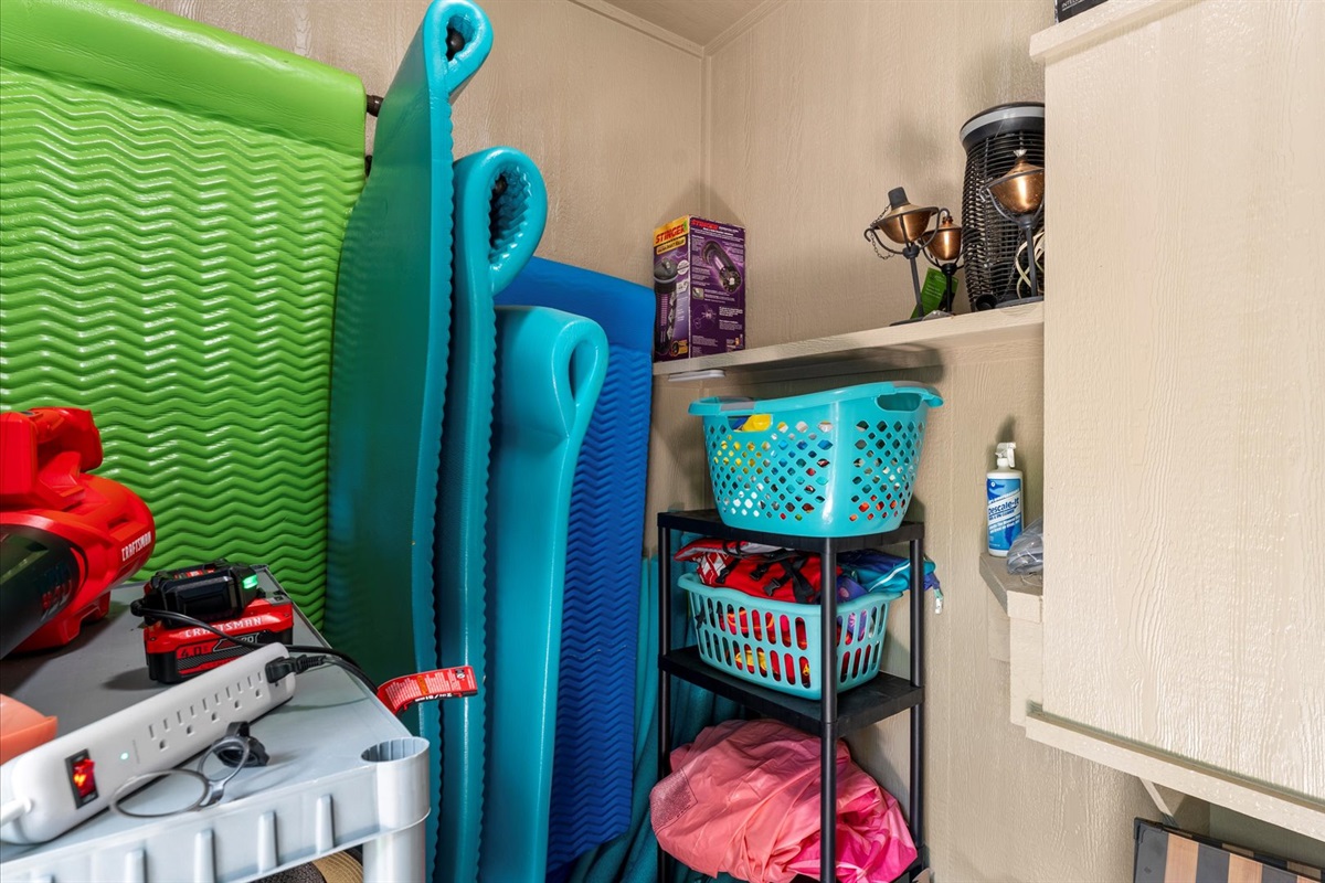 A well-stocked pool storage area filled with float mats, life vests, and outdoor essentials—everything you need for a fun and relaxing day by the pool!