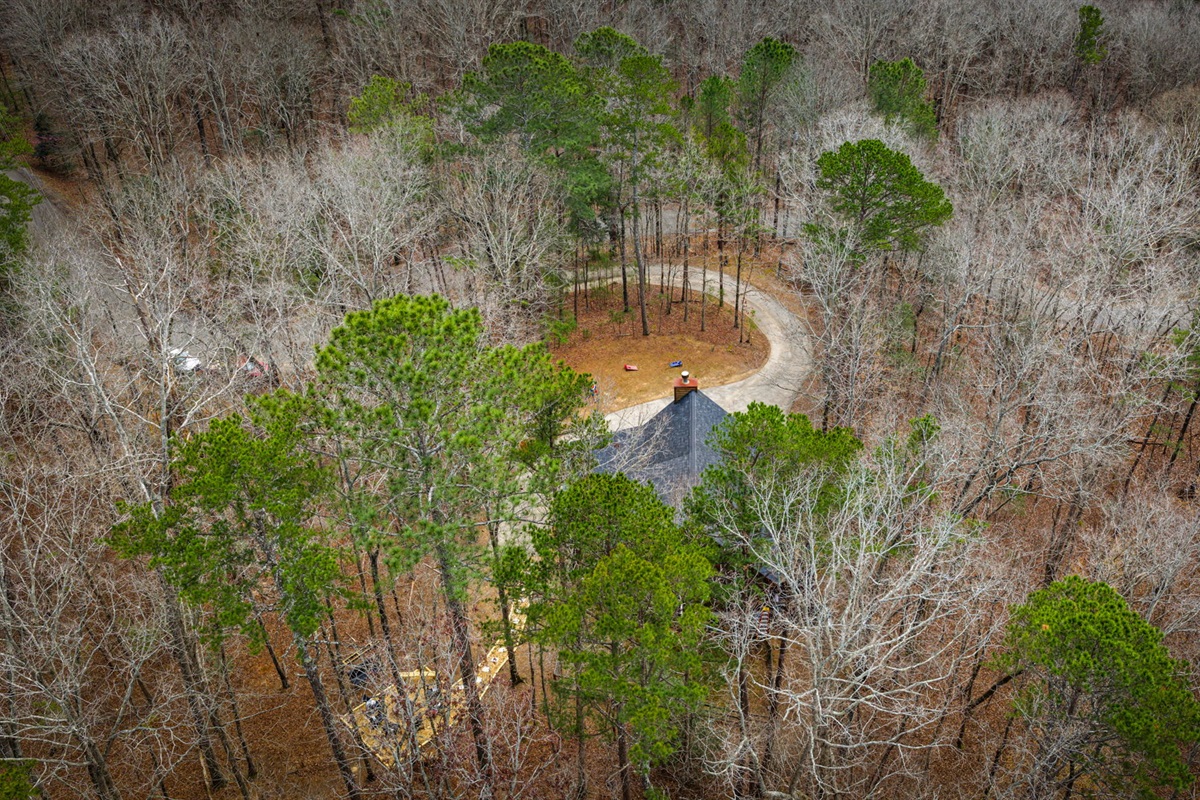 Beautiful aerial shot of the cabin, with the road access.