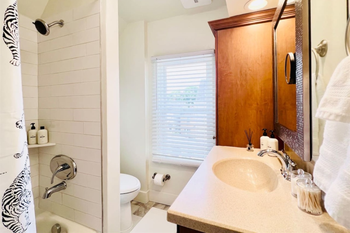 Modern full bathroom, featuring sleek fixtures and all the amenities you need for a comfortable and refreshing experience.