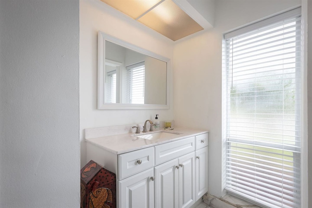 Master bathroom with shower and walk-in closet. Large mirror and vanity, plenty ofstorage space. Relax in a steamy shower after a day of golf at Palm Aire Country Club.