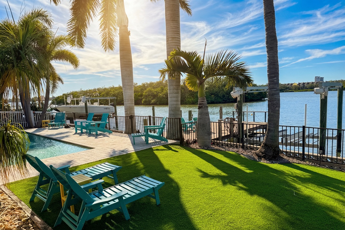 Waterfront yard with dock for fishing and launching paddle boards and kayaks and turf for chilling