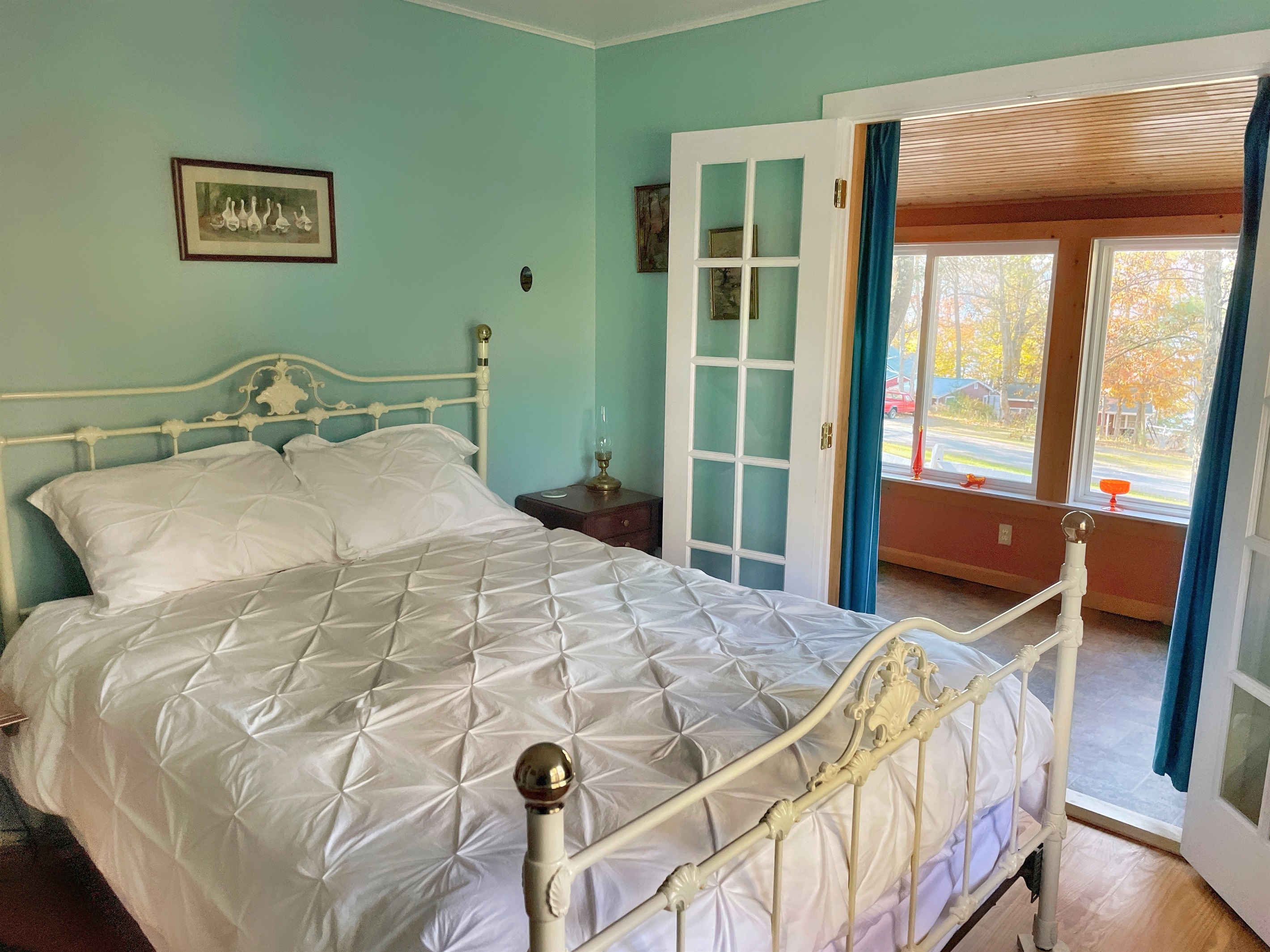 Big Pines queen bedroom with French doors leading to sun porch.