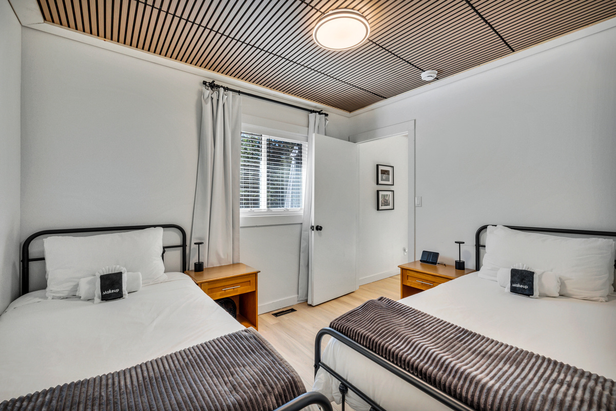 Two twin beds make this bright bedroom a comfortable choice for kids, friends, or anyone who prefers their own sleeping space.