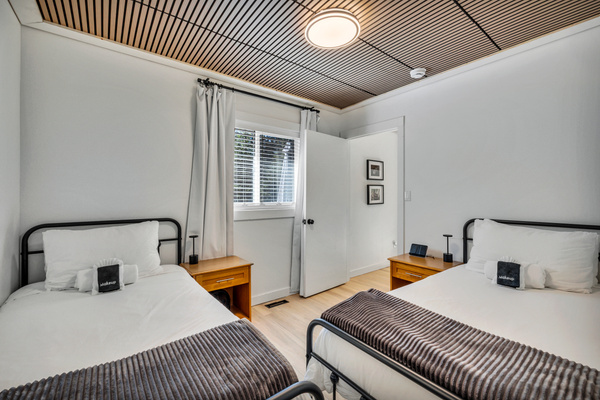 Two twin beds make this bright bedroom a comfortable choice for kids, friends, or anyone who prefers their own sleeping space.