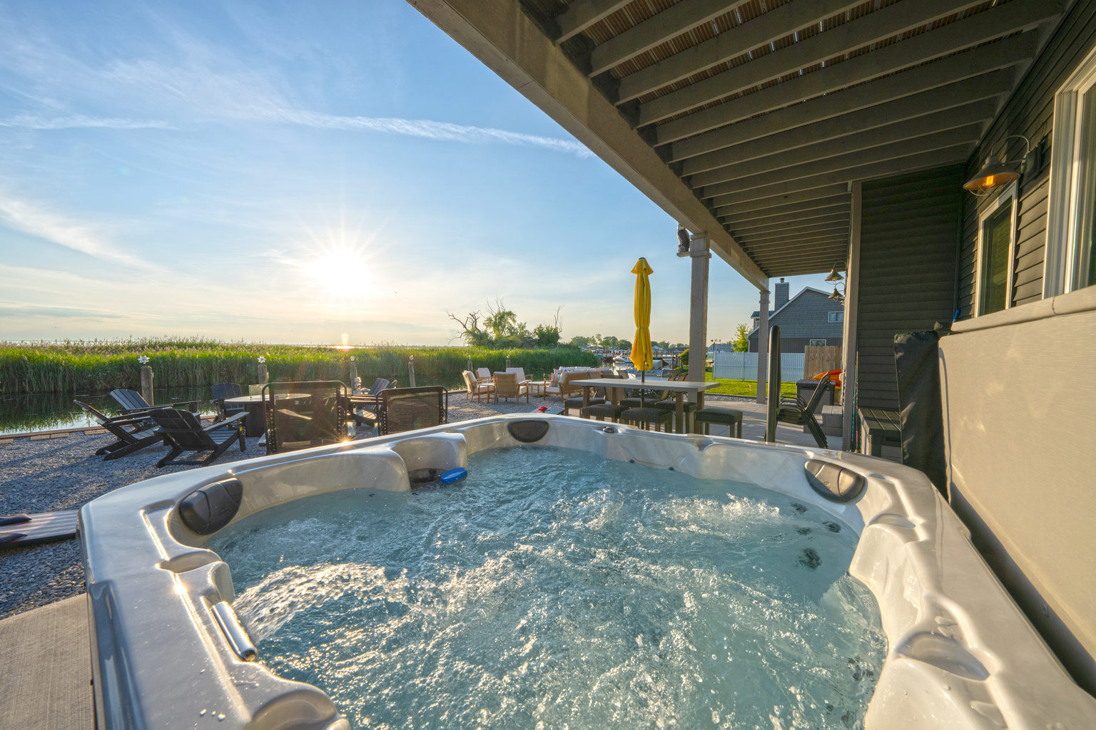 Relax in the private hot tub under the covered patio while enjoying the sunset. The perfect spot to unwind after boating, fishing, or exploring Lake Saint Clair. 