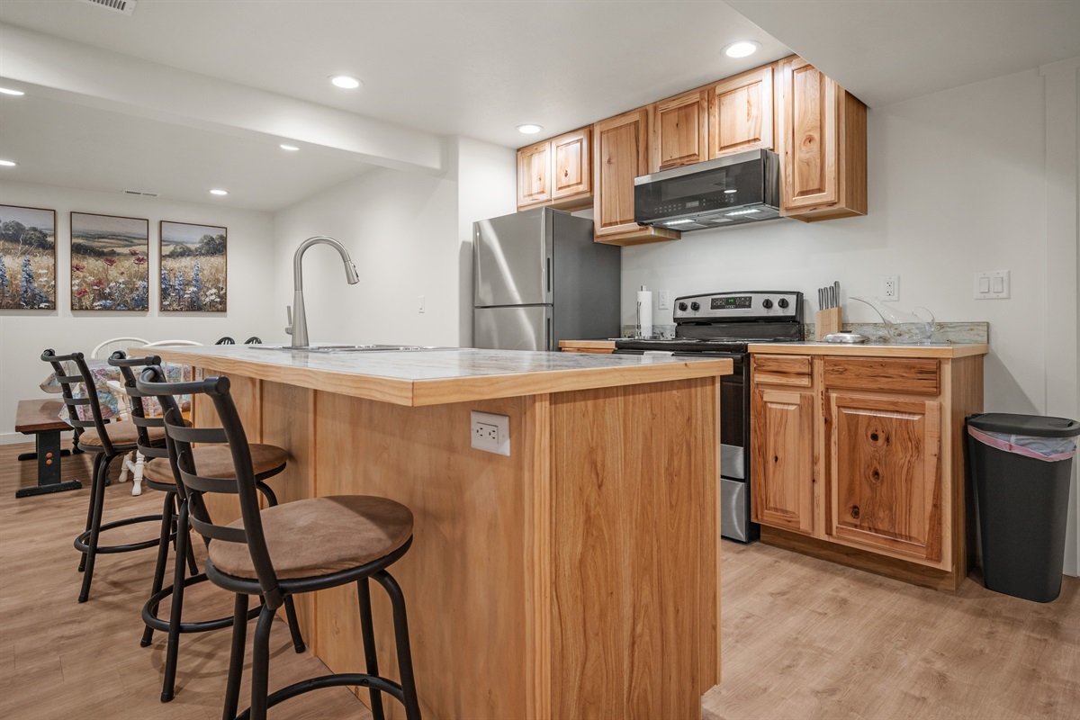 Fully equipped kitchen with breakfast bar and dining area.