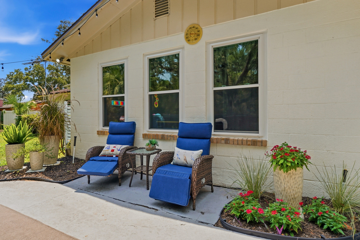 Settle into the reclining patio chairs and enjoy a quiet moment surrounded by colorful landscaping.