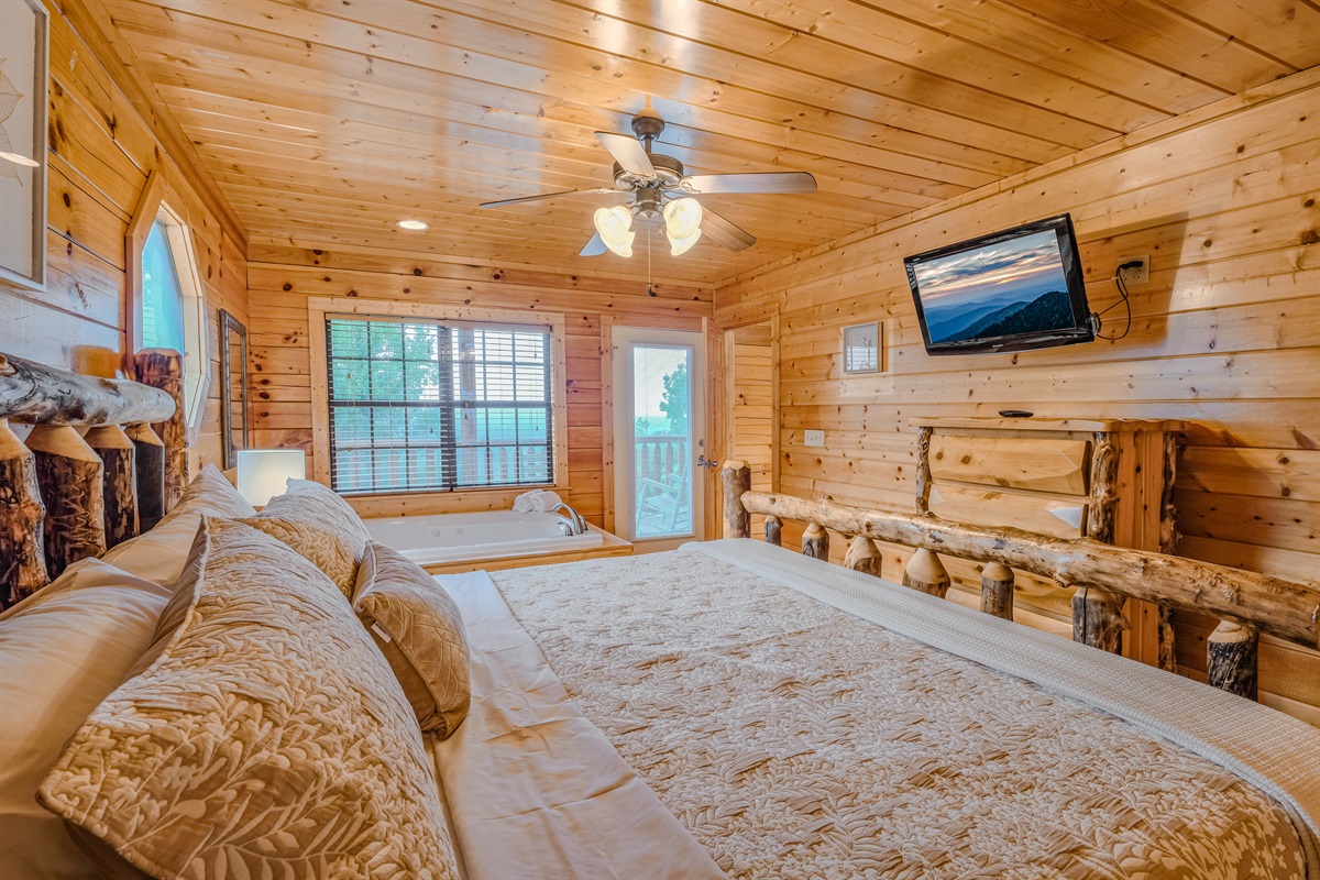 Master bedroom with king bed, jacuzzi, TV and private access to the deck